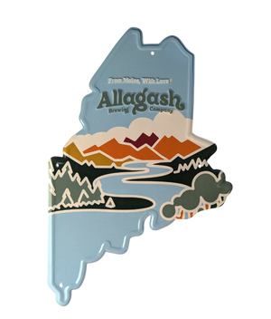 A decorative metal tacker sign with a silhouette of Maine, featuring the Allagash brand logo and colorful mountainous terrain.