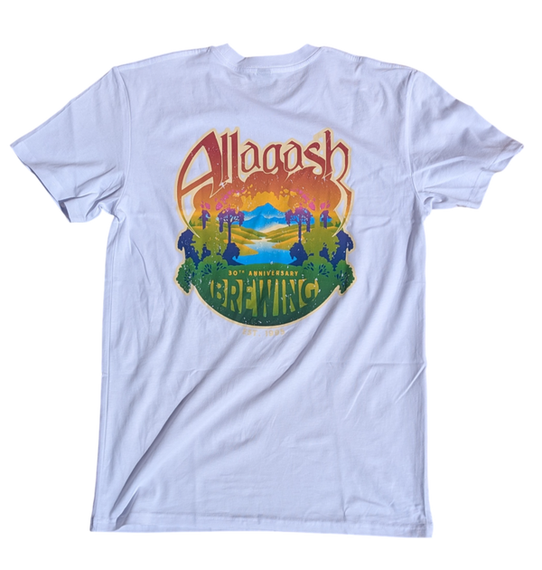 A white t-shirt with a colorful graphic print in the center, featuring text and a retro design.