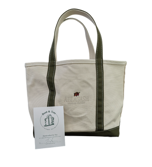 White tote bag with green accents. Leaf logo with white "Allagash Brewing Company" text.