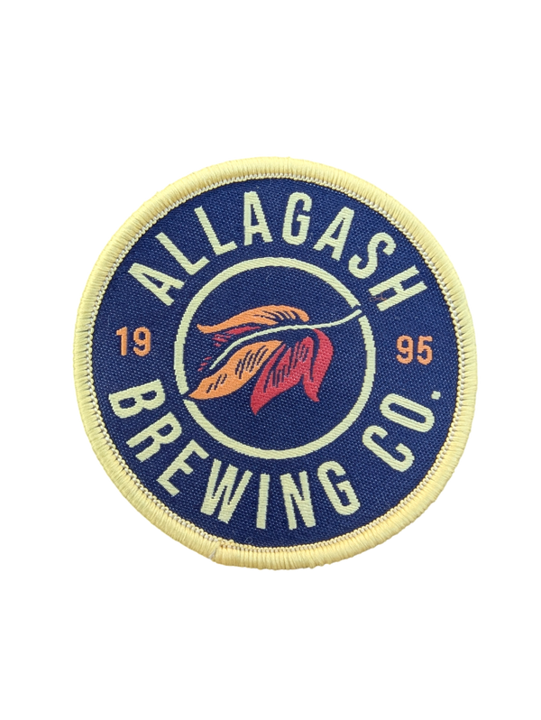 A round patch with the Allagash Brewing Co. logo, blue in color, with the text '1995' and 'ALLAGASH BREWING CO.'