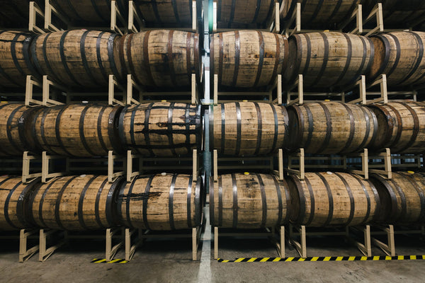 barrels stacked horizontally on racks.