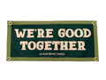 Green sign with 'WE'RE GOOD TOGETHER' text on a white background
