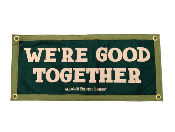 Green sign with 'WE'RE GOOD TOGETHER' text on a white background
