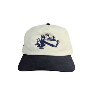 Cap with navy blue brim and white top featuring an soccer design on a white background